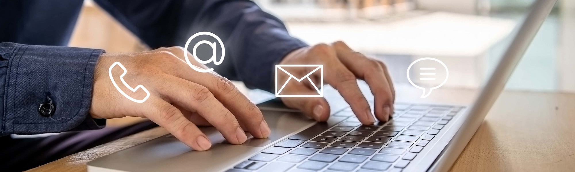 typing on laptop with contact icons floating above