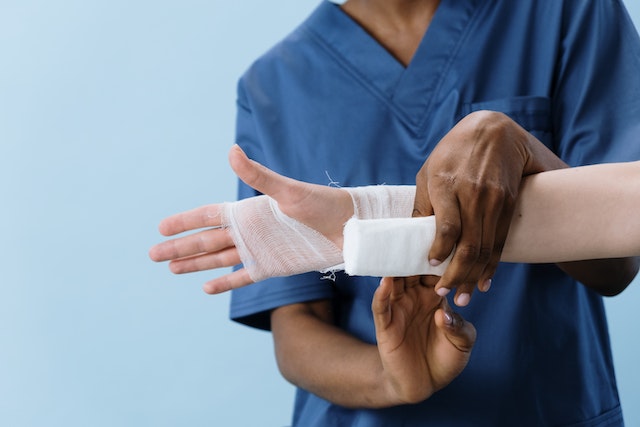 medical provider wrapping injured wrist